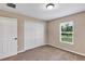 Neutral bedroom features a closet, a bright window and a carpeted floor at 1883 Sw 160Th Pl, Ocala, FL 34473