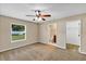 Bedroom boasts neutral walls, plush carpeting, a ceiling fan, and access to an ensuite bathroom at 1883 Sw 160Th Pl, Ocala, FL 34473