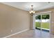Dining room features tile floors, a chandelier, and sliding glass door to a fenced backyard at 1883 Sw 160Th Pl, Ocala, FL 34473