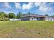 Single-story home featuring a big yard surrounded by a white fence providing a private and spacious outdoor area at 1883 Sw 160Th Pl, Ocala, FL 34473