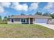 Charming single-story home showcasing a two-car garage, well-kept lawn, and traditional architecture at 1883 Sw 160Th Pl, Ocala, FL 34473