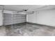Attached single car garage with grey door and automatic opener with concrete floors at 1883 Sw 160Th Pl, Ocala, FL 34473