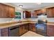 Modern kitchen with dark cabinetry, granite countertops, stainless steel appliances, and recessed lighting at 1883 Sw 160Th Pl, Ocala, FL 34473