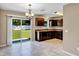 Open kitchen with dark cabinets, granite counters, tile floors, and sliding door to a spacious backyard at 1883 Sw 160Th Pl, Ocala, FL 34473