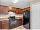 Contemporary kitchen featuring black appliances, ample cabinet space and sleek countertops and an adjacent pantry at 1883 Sw 160Th Pl, Ocala, FL 34473