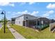 Backyard view of pool and patio, grassy area, and house at 1970 Summer Dr, Davenport, FL 33897