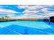 Enjoy a full sized, bright blue basketball court on a sunny day, perfect for recreation and exercise at 1970 Summer Dr, Davenport, FL 33897