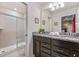 Bathroom features a double sink vanity with granite countertop and a glass-enclosed shower at 1970 Summer Dr, Davenport, FL 33897
