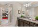 Well-lit bathroom with a granite countertop vanity and a view to a fun superhero-themed bedroom at 1970 Summer Dr, Davenport, FL 33897