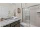 Well-lit bathroom features a granite countertop, vanity, and shower with glass doors, beautifully decorated at 1970 Summer Dr, Davenport, FL 33897