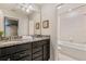 Bathroom with double sinks, granite countertop, and a view into themed bedroom at 1970 Summer Dr, Davenport, FL 33897
