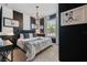 Tastefully decorated bedroom with modern decor, elegant furnishings, and black and white striped accent wall at 1970 Summer Dr, Davenport, FL 33897