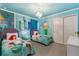 The Little Mermaid-themed bedroom boasts vibrant colors, custom murals, and whimsical decor for an enchanting stay at 1970 Summer Dr, Davenport, FL 33897
