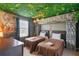 Indiana Jones-themed bedroom with jungle decor, themed artwork and ambient lighting creates an adventurous vibe at 1970 Summer Dr, Davenport, FL 33897