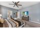Relaxing bedroom with a comfy bed, dresser, and easy access to an en-suite bathroom and nearby room at 1970 Summer Dr, Davenport, FL 33897