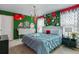 Charming themed bedroom with a bright blue bed, whimsical decor, and playful 'Alice in Wonderland' accents at 1970 Summer Dr, Davenport, FL 33897