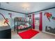 Vibrant bedroom with bunk beds, superhero wall art, and lively red accents at 1970 Summer Dr, Davenport, FL 33897