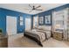 Serene bedroom with a plush bed, two windows, and modern decor with blue accent wall and ceiling fan at 1970 Summer Dr, Davenport, FL 33897