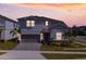 Charming two-story home features a well-maintained lawn, landscaped yard, and attached two-car garage at 1970 Summer Dr, Davenport, FL 33897
