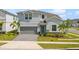 Beautiful two-story home features a well-maintained lawn, landscaped yard, and attached two-car garage at 1970 Summer Dr, Davenport, FL 33897