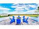Gather around the fire pit with blue Adirondack chairs and admire scenic views in this cozy outdoor space at 1970 Summer Dr, Davenport, FL 33897
