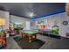 Spacious game room featuring a pool table, ping pong table, arcade games, and a colorful Mario mural at 1970 Summer Dr, Davenport, FL 33897