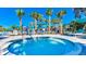 Relaxing hot tub with seating surrounded by palm trees and sun umbrellas at 1970 Summer Dr, Davenport, FL 33897