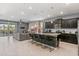 Modern kitchen with granite counters, stainless steel appliances, breakfast bar, and open layout to living room at 1970 Summer Dr, Davenport, FL 33897