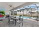 Inviting patio area featuring a dining table and seating, overlooking a sparkling swimming pool at 1970 Summer Dr, Davenport, FL 33897