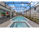 Beautiful screened-in pool and spa with brick patio and mural at 1970 Summer Dr, Davenport, FL 33897