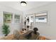 Office room with hardwood flooring, a large desk, shelving, and natural light from three windows at 205 W Princeton St, Orlando, FL 32804