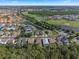 Aerial view of a residential area featuring homes near a green golf course and lakes at 2142 Victoria Dr, Davenport, FL 33837