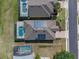 Birds eye view of homes with pools and solar panels in a residential neighborhood at 2142 Victoria Dr, Davenport, FL 33837