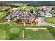 Aerial view showcasing the clubhouse, pool, parking, and golf course at 2142 Victoria Dr, Davenport, FL 33837