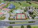 Aerial view of community amenities including pools, tennis courts, and playground at 2142 Victoria Dr, Davenport, FL 33837