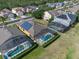 Aerial view of homes with solar panels and screened-in pools at 2142 Victoria Dr, Davenport, FL 33837