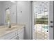 Bathroom features a white vanity with chrome fixtures and a sliding glass door to the patio at 2142 Victoria Dr, Davenport, FL 33837