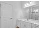 Bright bathroom featuring a white vanity with a large mirror and a walk-in shower at 2142 Victoria Dr, Davenport, FL 33837