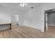 Spacious room featuring wood-look floors, ceiling fan, and access to an en-suite bathroom and walk-in closet at 2142 Victoria Dr, Davenport, FL 33837