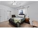 Bedroom features a window with sheer curtains, a comfortable bed, and a ceiling fan at 2142 Victoria Dr, Davenport, FL 33837