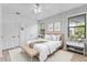 Comfortable bedroom with natural light, wood-look floors, and neutral decor at 2142 Victoria Dr, Davenport, FL 33837