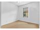 Bright bedroom with neutral carpet, white walls, and a window with blinds at 2142 Victoria Dr, Davenport, FL 33837