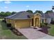 Charming single-story home with a brick driveway, two-car garage, and a well-maintained lawn at 2142 Victoria Dr, Davenport, FL 33837