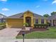 Charming single-story home with a well-maintained lawn and colorful landscaping at 2142 Victoria Dr, Davenport, FL 33837