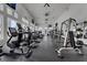 Bright gym featuring modern exercise equipment, high ceilings, large windows, and mounted TVs at 2142 Victoria Dr, Davenport, FL 33837