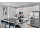Bright kitchen boasts an island with seating, stainless steel appliances, and white cabinetry at 2142 Victoria Dr, Davenport, FL 33837