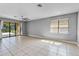 Spacious room featuring neutral paint, tile flooring, a ceiling fan, and a sliding door at 2142 Victoria Dr, Davenport, FL 33837