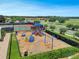 Aerial view of a community playground area with slides, swings, and climbing structures at 2142 Victoria Dr, Davenport, FL 33837