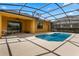 A screened-in pool area with a small pool and a large beige patio at 2142 Victoria Dr, Davenport, FL 33837