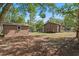 Expansive backyard with a detached shed and a cozy porch, surrounded by lush greenery and trees at 216 S Holly Ave, Sanford, FL 32771